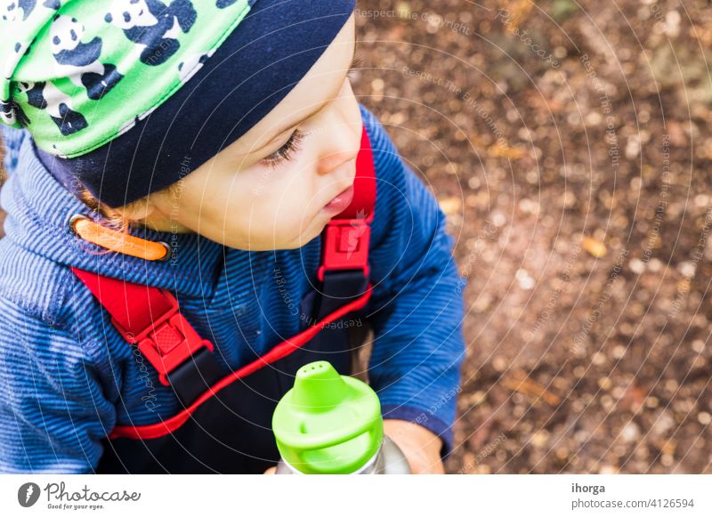 baby playing on a forest path in autumn adventure alone back boy child childhood day fall freedom fun halloween happy hiking independent individual kid