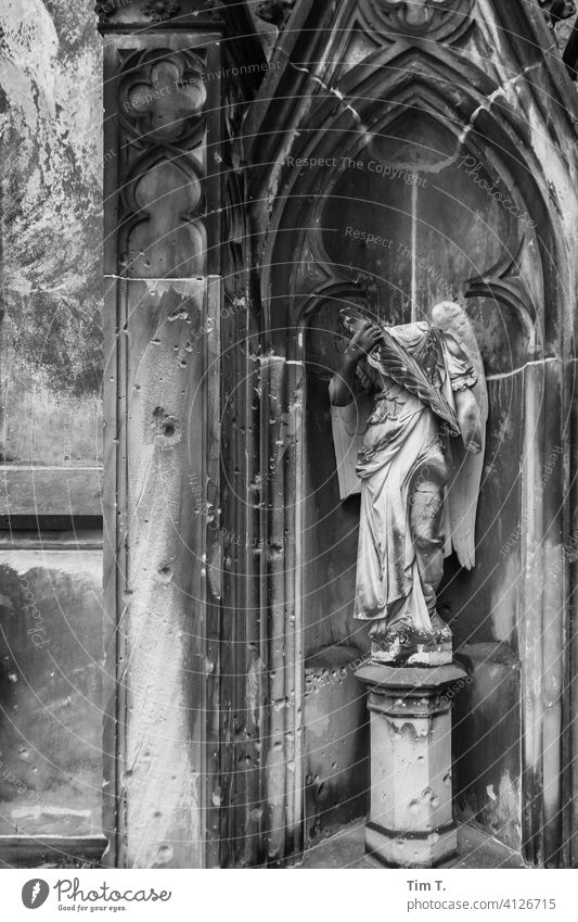 an angel with traces of war in a cemetery Cemetery Berlin Black & white photo Exterior shot Deserted Tombstone Death Grief Grave Transience Religion and faith