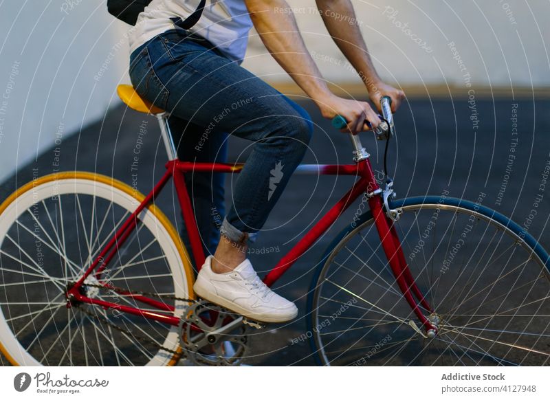 Unrecognizable man riding a bike bicycle fixie urban wheel fixed sport transportation gear lifestyle wall street hipster ride pedal biking chain action cyclist