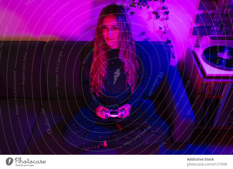 Happy girl playing video games at night computer gaming entertainment gamer fun young player arcade digital technology home console virtual joystick competition