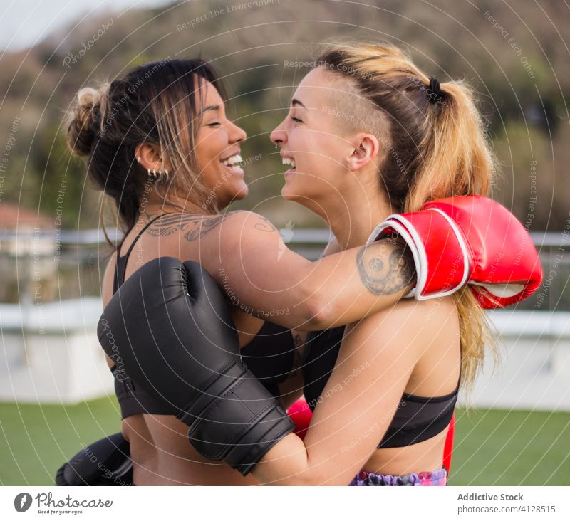 https://www.photocase.com/photos/4128515-cheerful-female-boxers-in-gloves-embracing-women-photocase-stock-photo-large.jpeg
