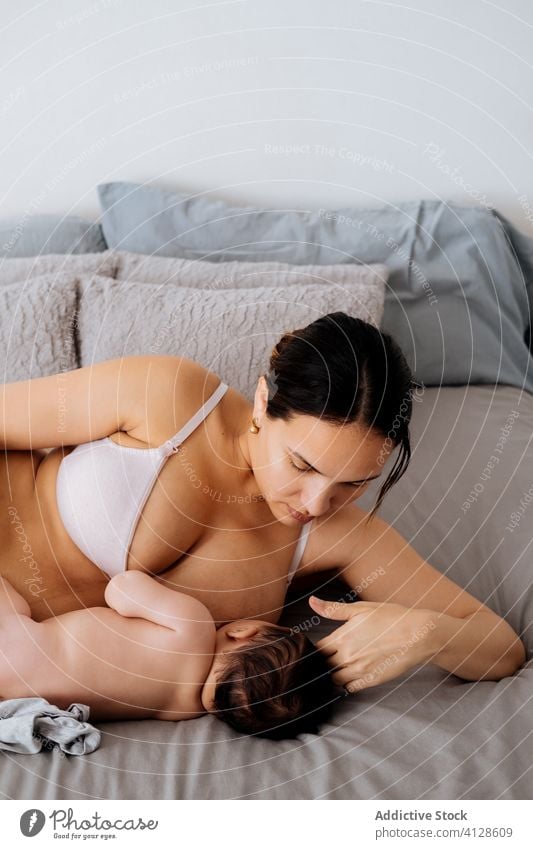 https://www.photocase.com/photos/4128609-mother-breastfeeding-little-baby-on-bed-woman-photocase-stock-photo-large.jpeg