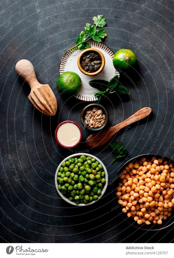 Chickpeas placed on a bowl near crackers chickpea oil health mint lebanese arab antipasti organic tasty veggies middle eastern top view dinner background spread