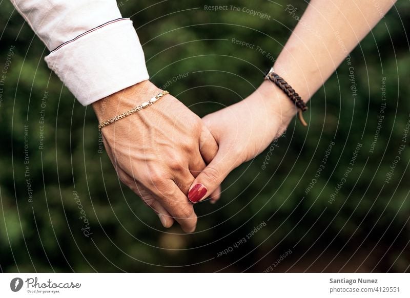 Close up portrait of a cute young caucasian blonde couple trying to kiss  where man is holding his girlfriend face in his hands close outside while  dating. Stock Photo