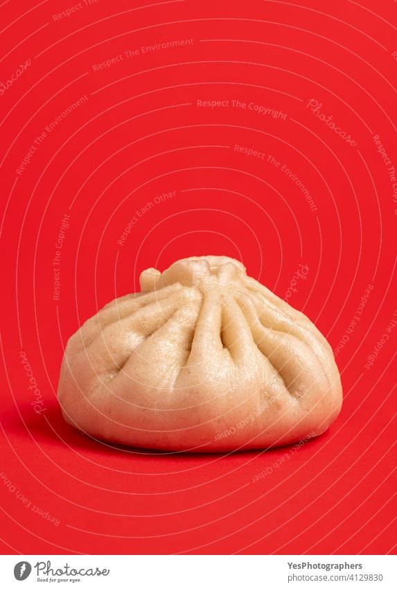 Bao dumpling minimalist isolated on a red background. asian asian food bao baozi bun chinese chinese food close-up color colorful cuisine culture cut out