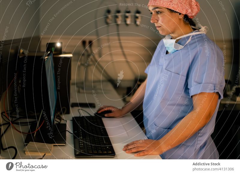 Doctor using computer in lab woman doctor laboratory work hospital modern dark examine female data medical practitioner job expertise medicine clinic