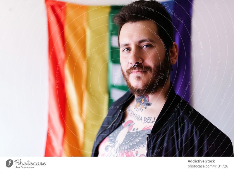 young Caucasian boy with a beard peace lgbt pride rainbow flag tattoo community right diversity equality proud human support colourful respect gay individuality