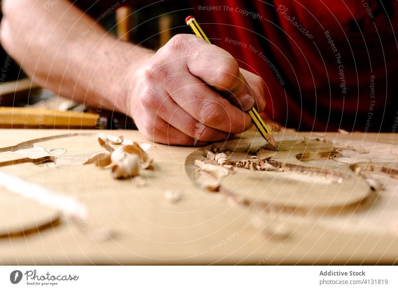 Craftsman carving elements on wood in workshop carve chisel woodwork craftsman ornament tool equipment woodworker artisan male professional occupation job skill