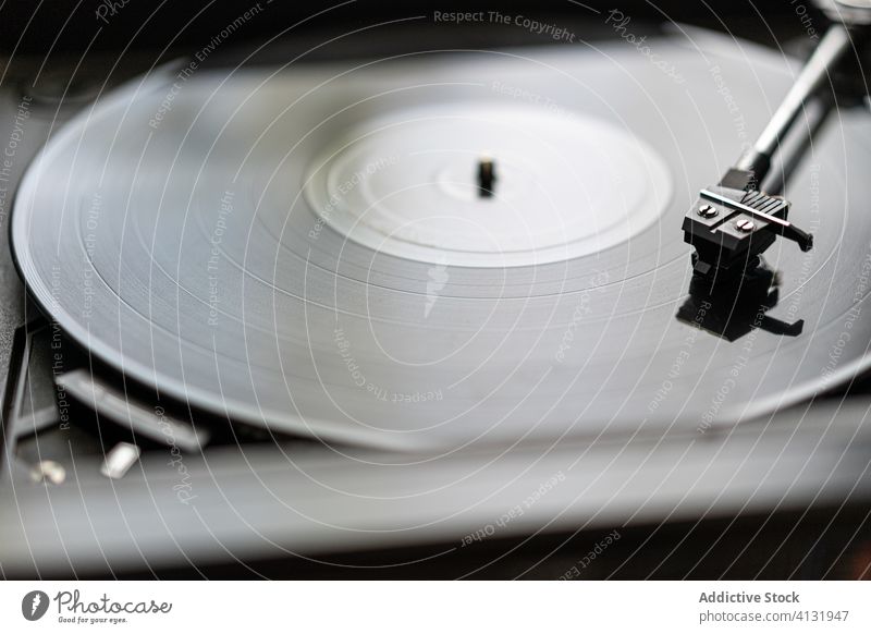A vinyl record is spinning on a record player music turntable sound old entertainment disc retro audio vintage gramophone analog stereo equipment technology