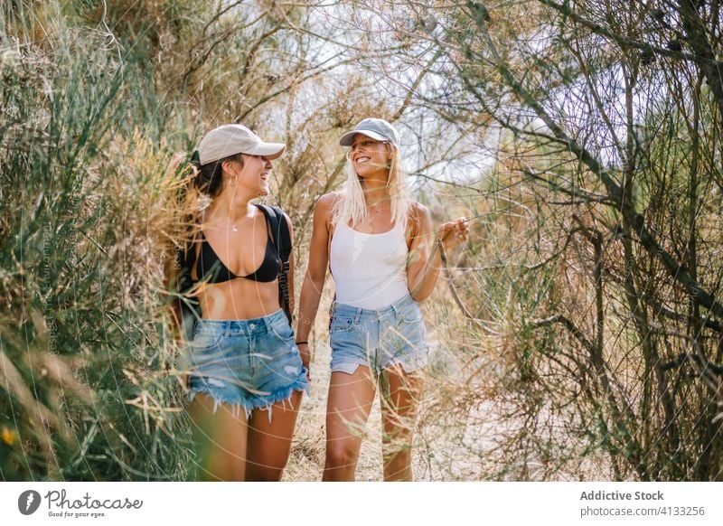 Traveling women on green hill vacation summer friend together travel sunny tourist cheerful friendship friendly grass enjoy nature smile happy holiday weekend