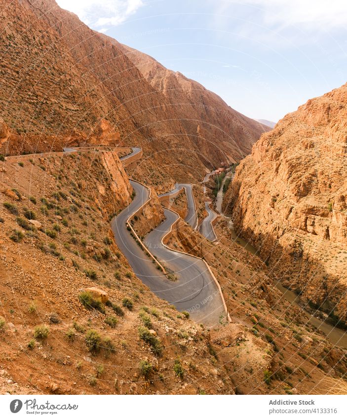 Winding road in mountainous area on sunny day winding roadway rock landscape narrow majestic rough morocco africa nature scenic route journey tranquil stone