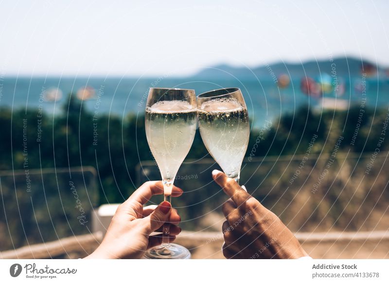 https://www.photocase.com/photos/4133678-couple-clinking-champagne-glasses-at-seaside-photocase-stock-photo-large.jpeg