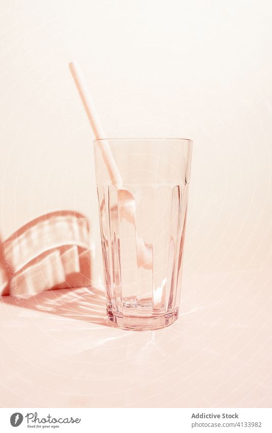 Empty glass with straw in studio empty glassware crystal drink beverage refreshment transparent cold plastic summer serve creative simple minimal shadow shiny