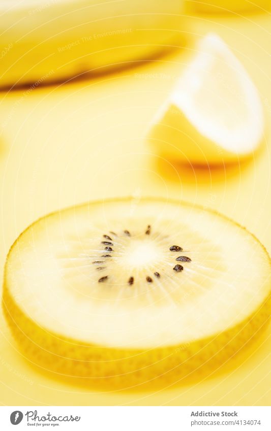 Refreshing fruits on yellow background color vibrant vivid creative healthy food arrangement various composition vitamin citrus organic lemon kiwi summer mix