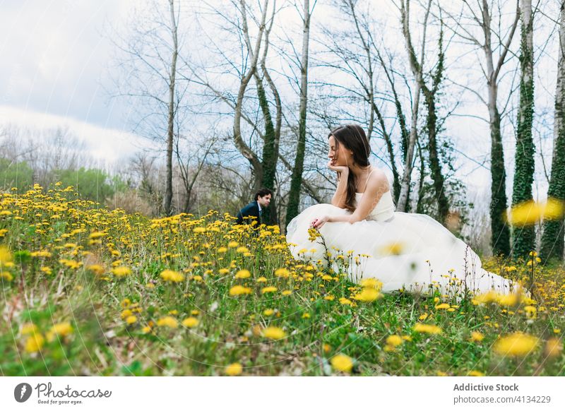 Content bride in blossoming meadow with yellow dandelions newlywed wedding wedding dress flower green wedding day female bloom gorgeous grass flower in hair