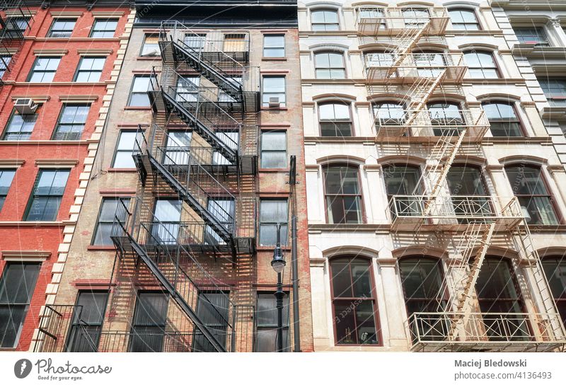 Old buildings with iron fire escapes, New York City, USA. city Manhattan old townhouse architecture stairs apartment facade NYC ladder view residential urban