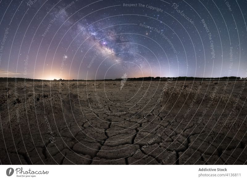 Dry desert in starry night sky milky way drought nature surface dry crack landscape scenery tourism travel global warm arid climate environment wild dark