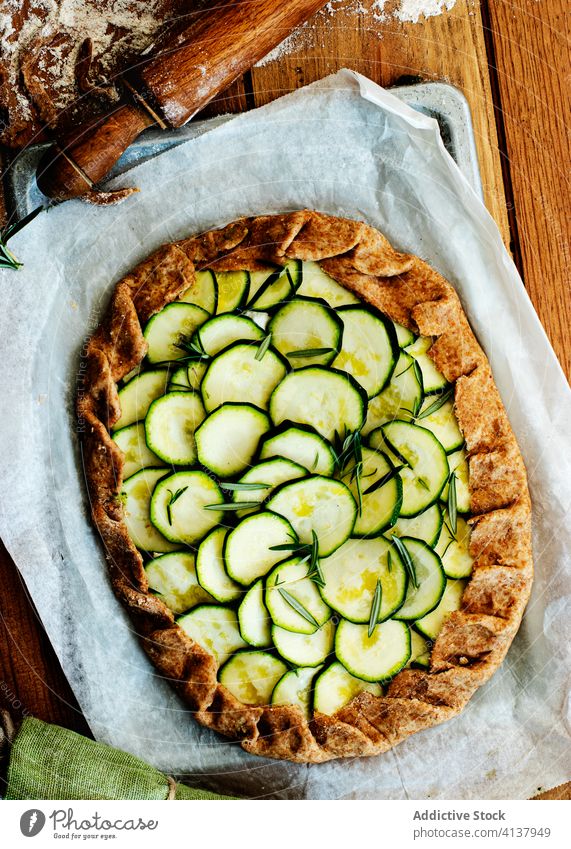 Zucchini galette on wooden table nutritionist tasty brunch feta cheese seasonal vegan cooking recipe healthy eating appetizers dining baked parchment paper