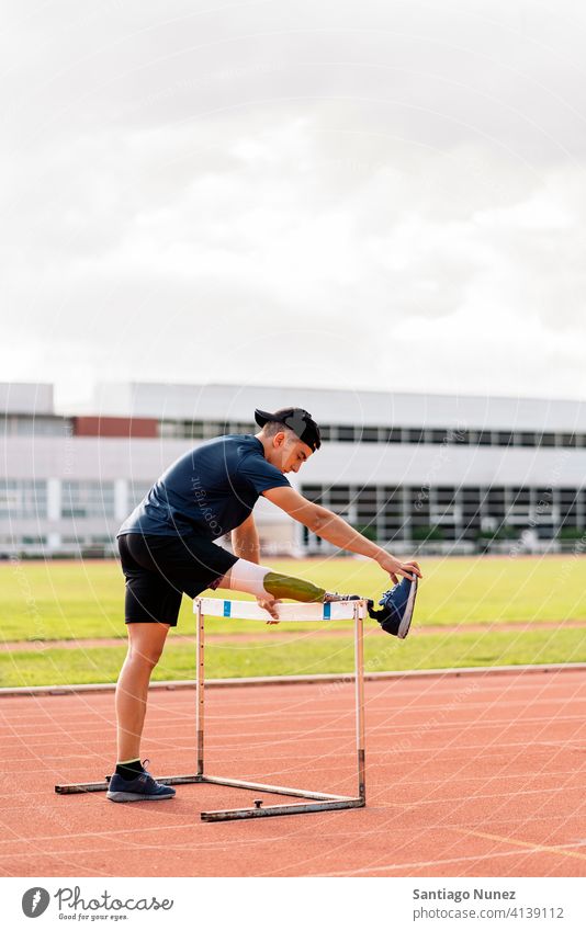 Disabled man athlete stretching with leg prosthesis. runner sport prosthetic disability disabled amputation amputee invalid invalidity fast active training