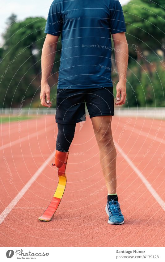 Close up disabled man athlete with leg prosthesis. runner portrait sport legs prosthetic faceless unrecognized anonymous sports wear sports clothes disability