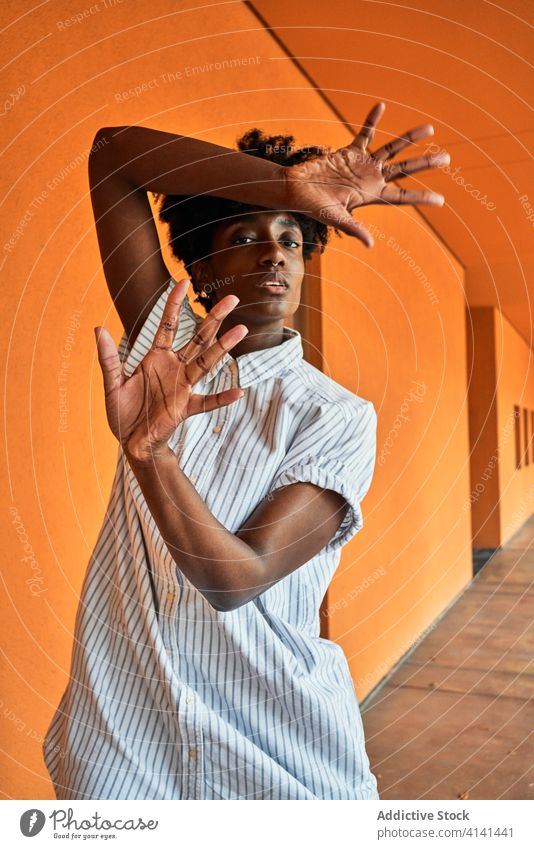 Serious black woman with hands raised protesting and trying to stop violence prevent against gesture sign dissuade objection concept renouncement refuse serious