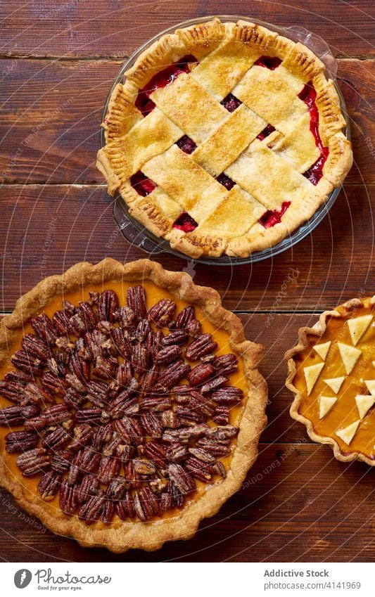 Variety of thanksgiving pies on wooden table. food pecan apple pumpkin variety season autumn baking dinner seasonal round traditional closeup fresh cuisine