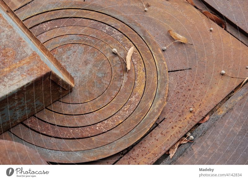 Rusty old stove plate with concentric circles of an old stove with grill in autumn outside on a farm in Rudersau near Rottenbuch in the district of Weilheim-Schongau in Upper Bavaria