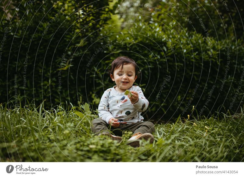 Child playing in the park 1 - 3 years Caucasian Authentic Nature Green Day Human being Infancy Colour photo Lifestyle Exterior shot Toddler Joy Happiness