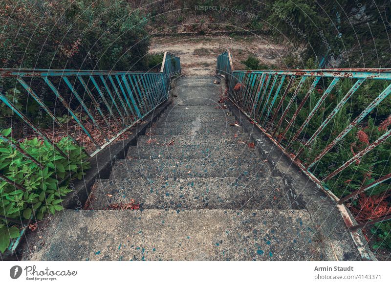 old concrete staircase with rusty blue railing abandoned ancient architecture background construction dirt down gray grunge handrail iron life metal nature