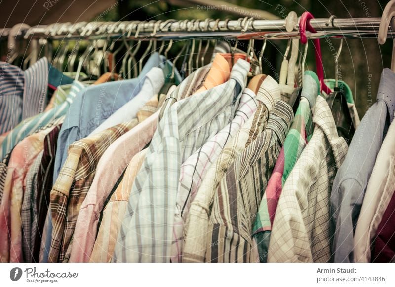 Fashionable stylish women's clothing on a hanger. Close-up of branded  clothing in a show room. Light background. Fashion retail, show room,  shopping or seasonal sale concept. Selective focus - a Royalty Free