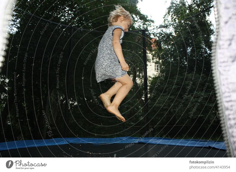 Child bouncing on a trampoline Trampoline Hop Skip Children's game Energized vitality Leisure and hobbies Gymnastics cheerful move Airy Joy jump feel free