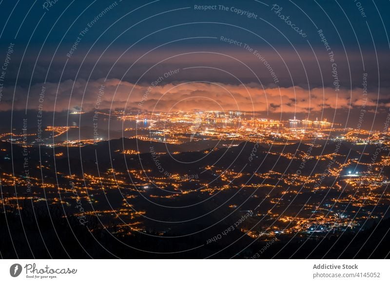 Amazing illuminated cityscape in evening night mountain amazing dark glow light scenery gran canaria spain cloudy sky dusk urban town landscape picturesque