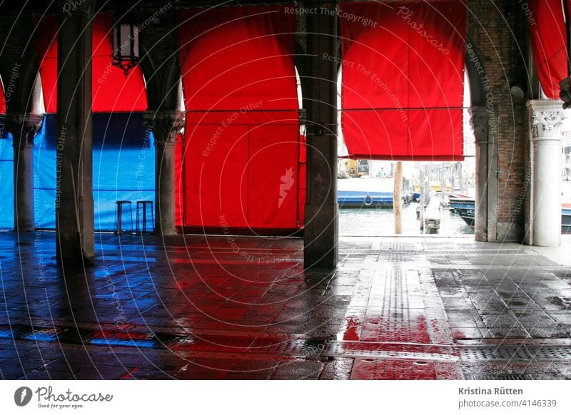 red blinds at the fish hall in venice Fish market Covered market Roller blinds Red Blue Arcade columns Architecture Empty Moody Closing time Wet pescheria