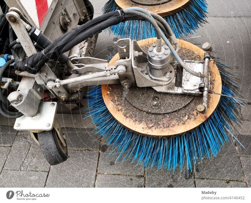 Sweeper with rotating blue bristles on a sidewalk in Offenbach am Main in Hesse, Germany Roadsweeper Bristles rotation Broom cleaning Street cleaning technique