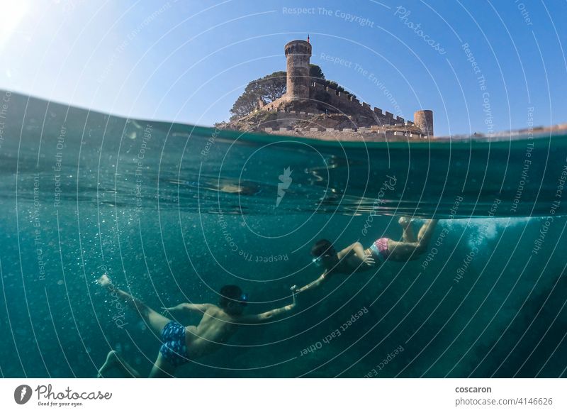 Two little boys snorkeling with a castle in the background apnea beach caribbean child childhood cute dive diver enjoying enjoyment exploration friends fun half