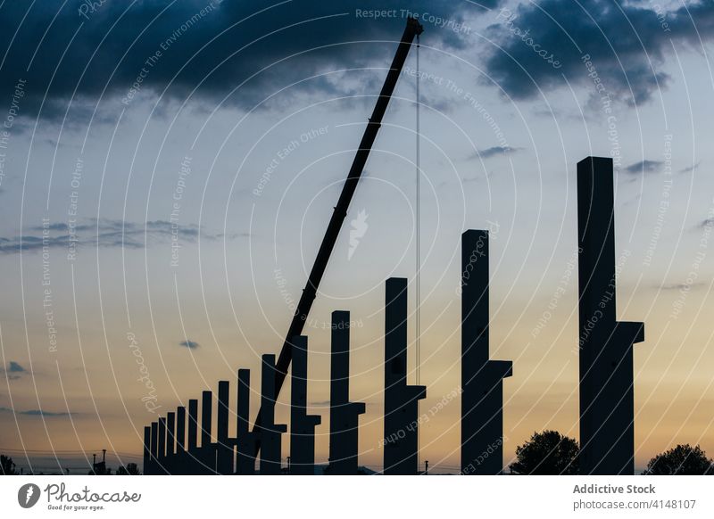 Silhoutte of construction site activity arquitecture build building building site cloud concrete crane engineering equipment foreman industril machinery pillar