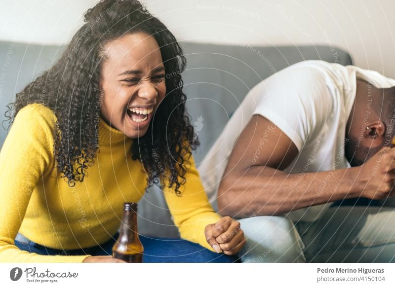 black couple laughing and drinking beer at home african party happy american alcohol fun friends smiling together friendship person female lifestyle people afro