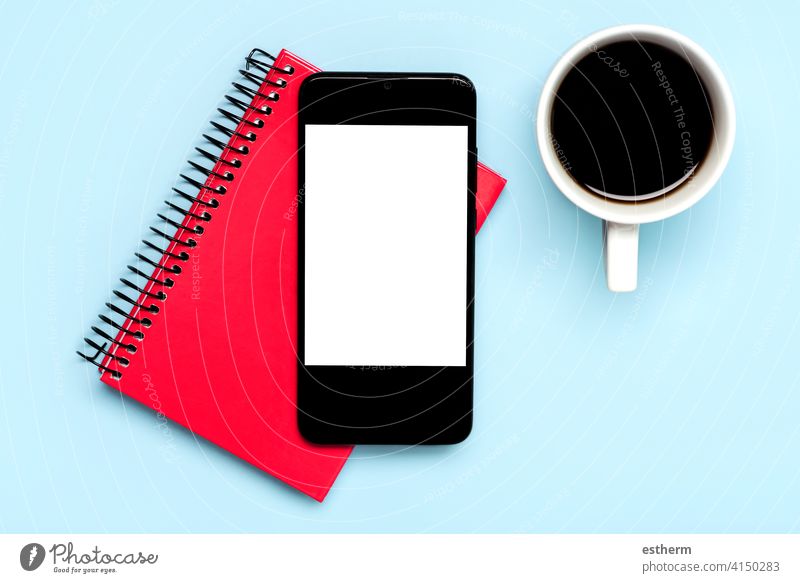smartphone with white screen for copy space with white cup of coffee and red diary office telecommunication networking message social banner lifestyle business