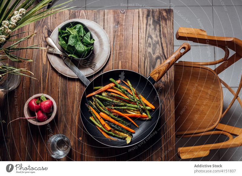 Carrot, asparagus and zucchini sauteed in the pan, on the table gourmet carrots concept modern mix new traditional background prepared recipe rustic vegetarian
