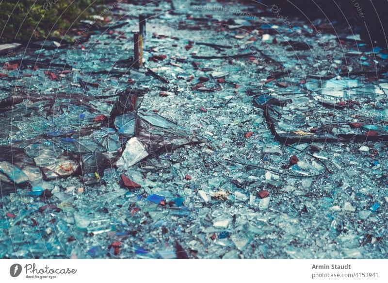close up of colorful glass shards covering the ground abstract accident background break broken crack cracked crash crushed damage debris destruction dust earth