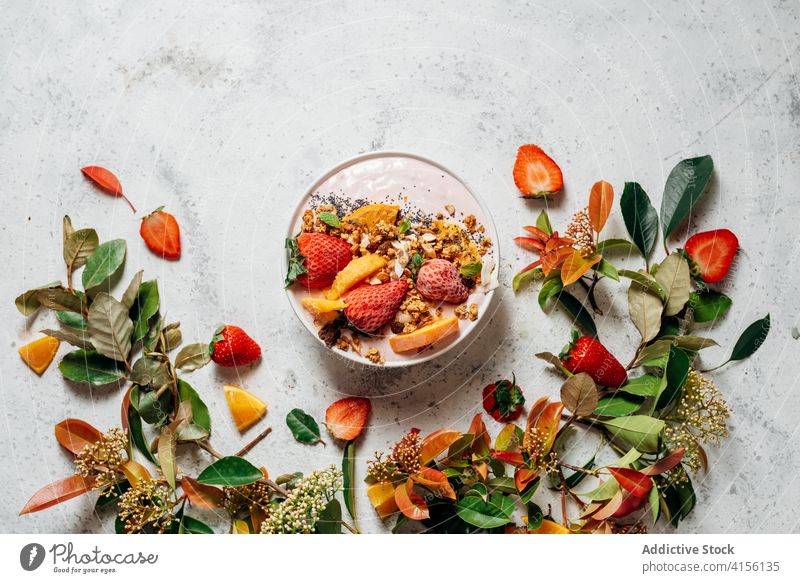 Healthy breakfast bowl with fruits on table smoothie bowl super food delicious nut nutrition healthy food raw food green plant muesli orange coconut various