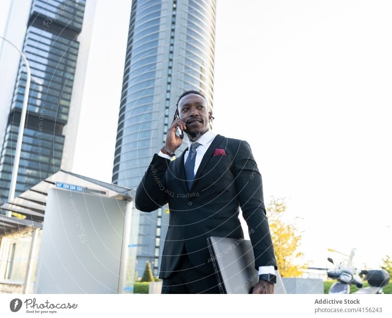 Busy male entrepreneur talking on smartphone in city businessman downtown away discuss busy suit using conversation ethnic black african american call device