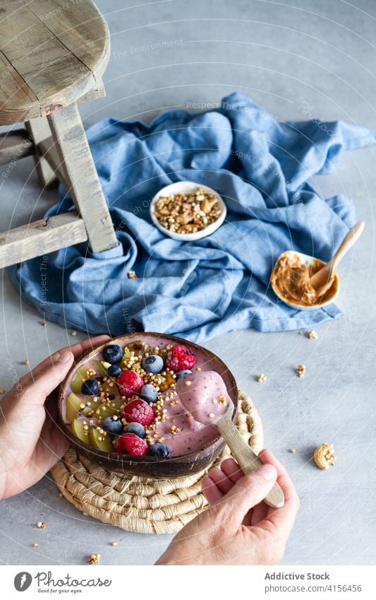 Crop woman with delicious smoothie bowl breakfast super food nutrition berry yogurt female healthy food tasty yummy diet natural raspberry blueberry lady peanut
