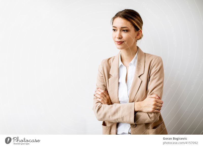 Young woman standing by the white wall in modern office adult attractive beautiful business businesswomen electronic female happy indoors looking manager one