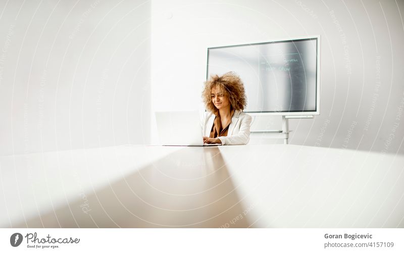 African American business woman standing in front of her team in office - a  Royalty Free Stock Photo from Photocase
