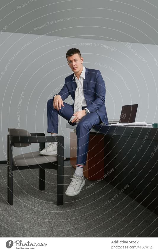 Stylish businessman sitting in office table entrepreneur style male workplace chair occupation rest job professional modern career connection handsome smart