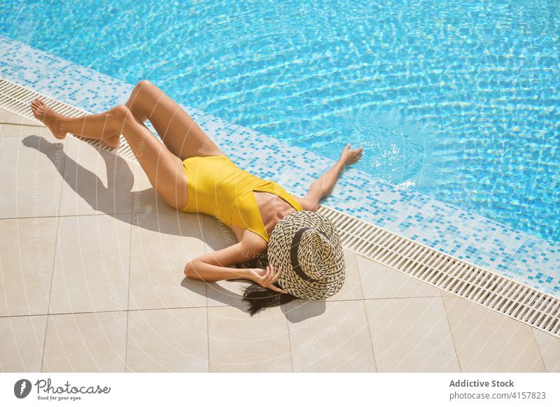 Anonymous young woman in bikini lounging in pool - a Royalty Free Stock  Photo from Photocase
