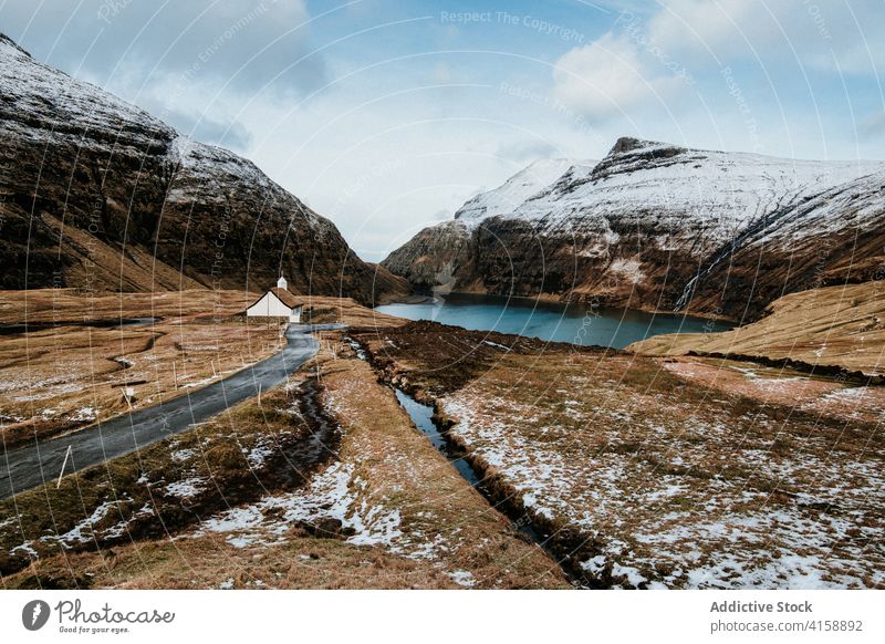 Small cabin wooden house in mountains on Faroe Islands village settlement winter snow river season cold residential faroe islands scenery breathtaking scenic