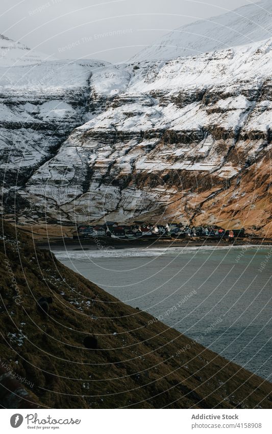 Small settlement in mountains on Faroe Islands village winter snow river season cold house residential faroe islands scenery breathtaking scenic countryside