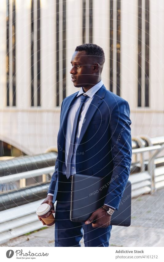 https://www.photocase.com/photos/4161212-stylish-executive-black-man-in-suit-walking-in-downtown-photocase-stock-photo-large.jpeg